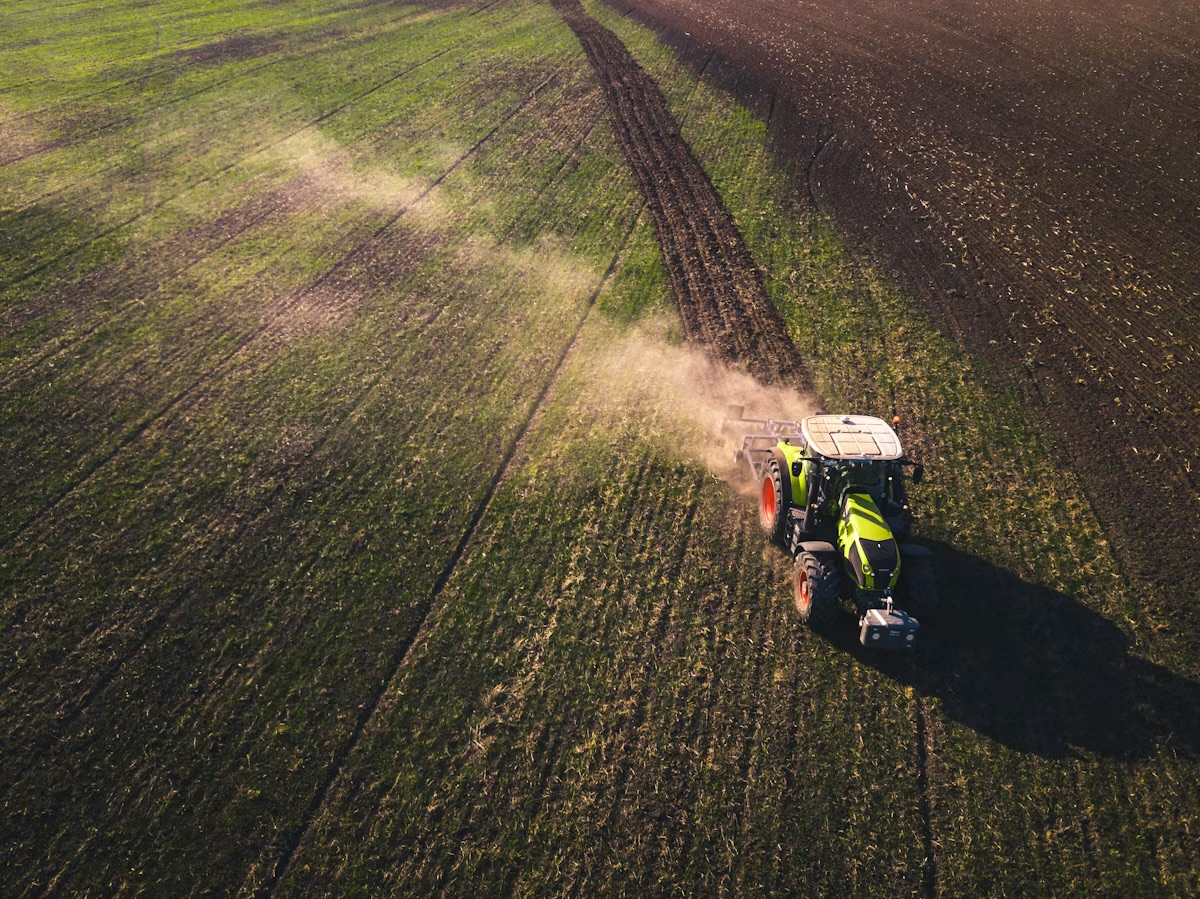 Aerial view of agricultural tractor working a field